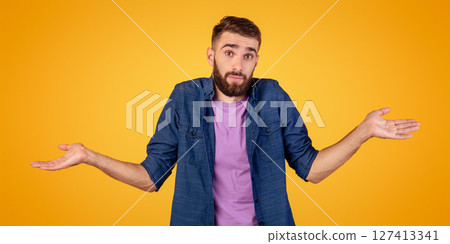 I don't know. Handsome Caucasian guy shrugging shoulders, feeling puzzled or uncertain on orange studio background. Confused millennial man expressing doubt, making difficult choice, panorama I don't know. Handsome Caucasian guy shrugging shoulders, feeling puzzled or uncertain on orange studio background. Confused millennial man expressing doubt, making difficult choice, panorama 127413341
