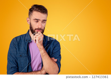 Dreamy young guy thinking over problem, touching his chin on grey studio background. Millennial hipster man making hard choice or decision, imagining something, having doubts Dreamy young guy thinking over problem, touching his chin on grey studio background. Millennial hipster man making hard choice or decision, imagining something, having doubts 127413361