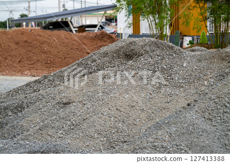 Ground level construction progress gravel and dirt piles at urban industrial site Ground level construction progress gravel and dirt piles at urban industrial site 127413388