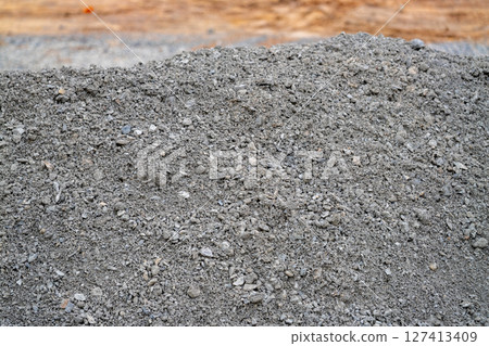 Outdoor construction site image gravel material usage from ground-level perspective Outdoor construction site image gravel material usage from ground-level perspective 127413409