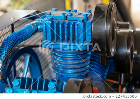 Industrial machinery operation factory floor equipment focus close-up mechanical components 127413500