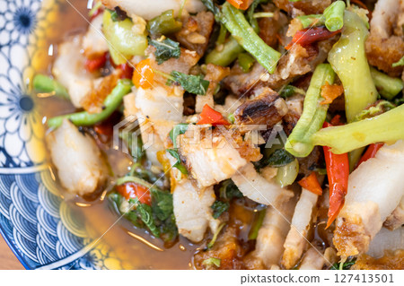 Flavorful spicy stir-fried pork dish local market food culinary scene close-up thai cuisine Flavorful spicy stir-fried pork dish local market food culinary scene close-up thai cuisine 127413501