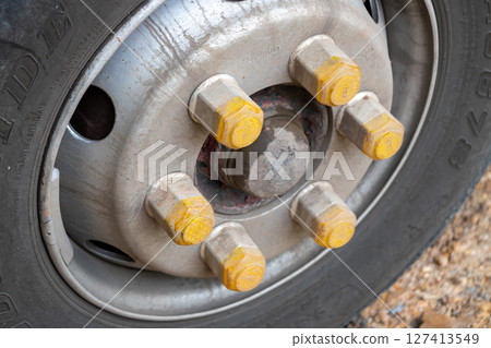 Truck wheel close-up workshop setting industrial equipment detailed focus mechanical concept 127413549