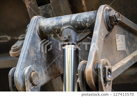 Heavy machinery action close-up construction site equipment in industrial setting Heavy machinery action close-up construction site equipment in industrial setting 127413570