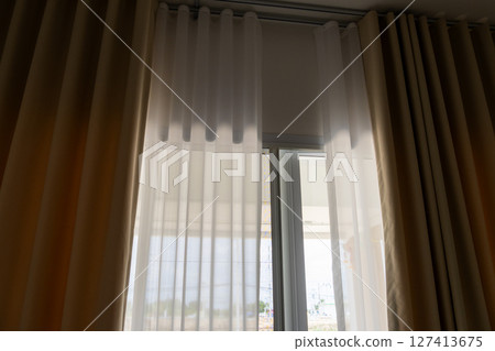 Light filtering through sheer curtains in modern living room indoor interior design bright atmosphere Light filtering through sheer curtains in modern living room indoor interior design bright atmosphere 127413675