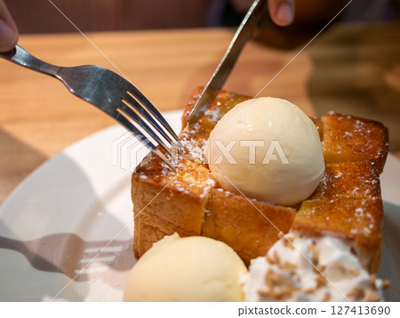 Indulge in toast and ice cream delight cozy indoor dining delicious dessert experience close-up view 127413690