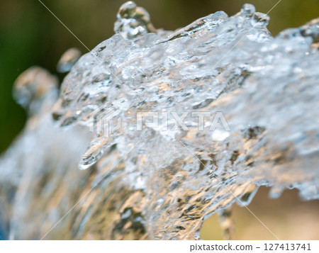 Flowing water action shot nature park macro tranquil environment close-up view water movement concept Flowing water action shot nature park macro tranquil environment close-up view water movement concept 127413741