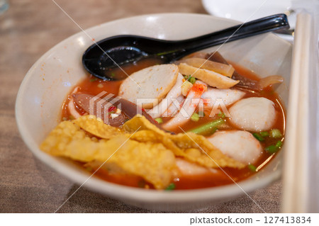 Delicious spicy noodle soup preparing event local eatery food cozy setting close-up view 127413834