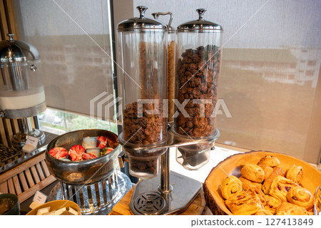 Delicious breakfast buffet display cozy atmosphere and gourmet experience at hotel restaurant Delicious breakfast buffet display cozy atmosphere and gourmet experience at hotel restaurant 127413849