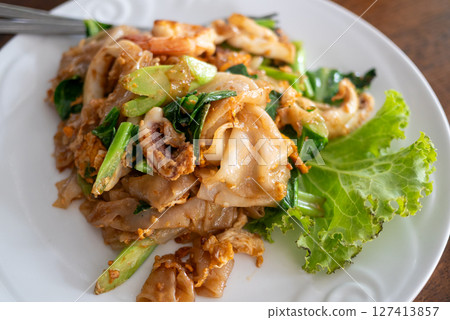 Delicious stir-fried noodles local eatery food casual setting close-up culinary delight 127413857