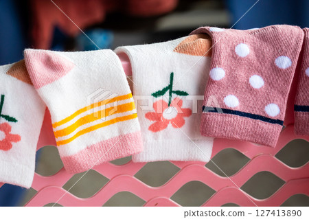 Colorful baby socks displayed a rack home product cozy environment close-up fashion Colorful baby socks displayed a rack home product cozy environment close-up fashion 127413890