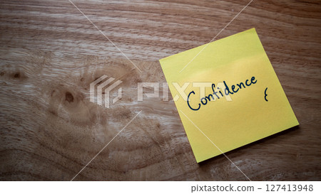 Empowering thought confidence note wooden desk office space still life personal growth perspective 127413948