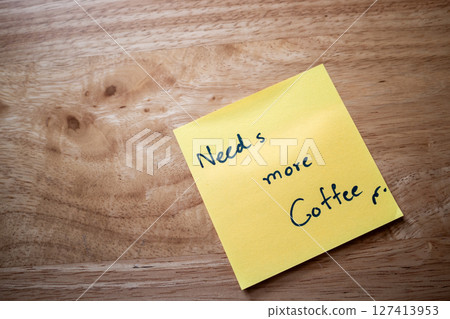 Morning coffee reminder note office desk sticky note casual environment close-up view motivation concept 127413953
