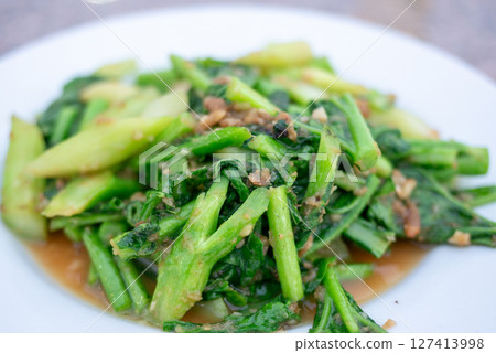 Healthy stir-fried greens recipe kitchen food indoor close-up nutritional benefits 127413998