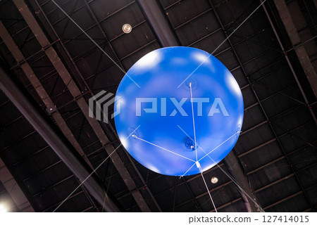 Aerial demonstration of a blue balloon indoor exhibition modern environment upward view aviation concept 127414015