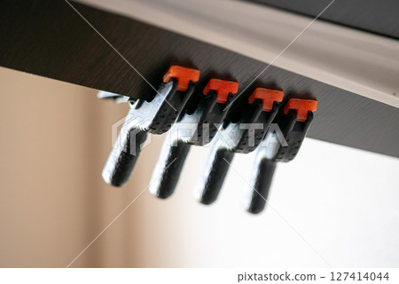 Clamping technique demonstration in workshop woodworking tools indoor close-up craftsmanship 127414044