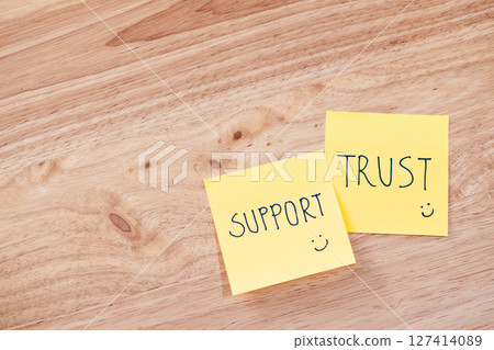 Support and trust in teamwork office space text notes professional setting top view team collaboration 127414089