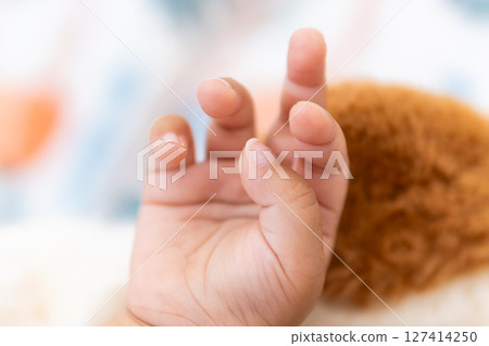 One year old asian girl's tiny hand reaching out home candid cozy close-up innocence One year old asian girl's tiny hand reaching out home candid cozy close-up innocence 127414250