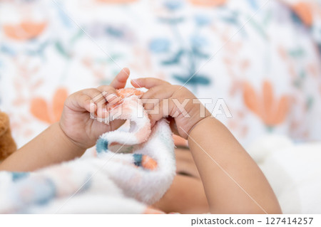 One year old asian girl playing with soft toy at home captivating baby moment indoor bliss 127414257