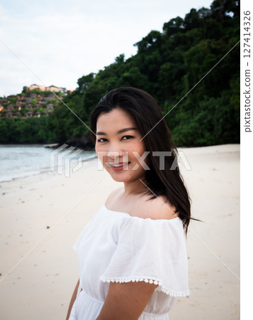 Captivating travel moments a woman enjoys thailand's serene beach portrait coastal paradise natural beauty 127414326