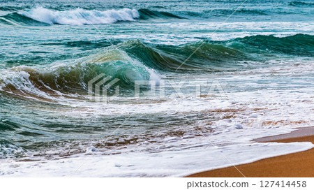 Dynamic ocean waves crashing sandy shoreline natural beauty coastal viewpoint tranquil environment Dynamic ocean waves crashing sandy shoreline natural beauty coastal viewpoint tranquil environment 127414458