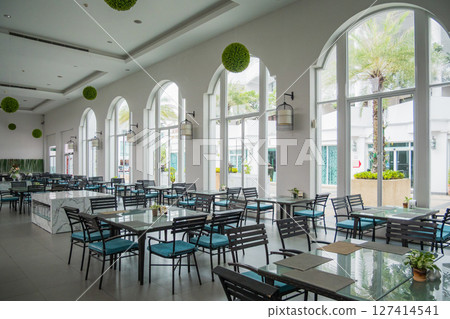 Elegant restaurant interior with arched windows modern design bright atmosphere inviting space Elegant restaurant interior with arched windows modern design bright atmosphere inviting space 127414541