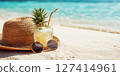 Straw hat, sunglasses and cocktail on the sand and sea background. Relax on the beach 127414961