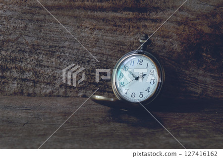 Vintage Locket Watch on wood Background. 127416162
