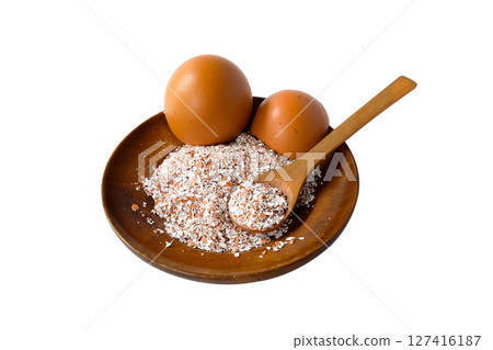 Broken or Crushed Egg Shells on Wood plate. Broken or Crushed Egg Shells on Wood plate. 127416187