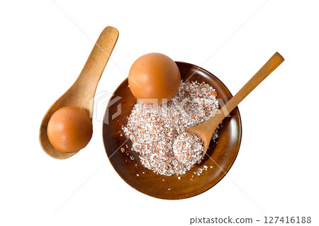 Broken or Crushed Egg Shells on Wood plate. Broken or Crushed Egg Shells on Wood plate. 127416188