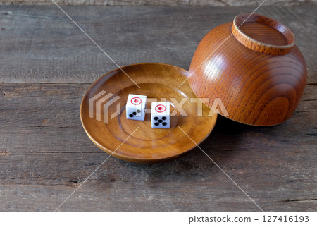 Dice on a wood plate on wood Background. Dice on a wood plate on wood Background. 127416193