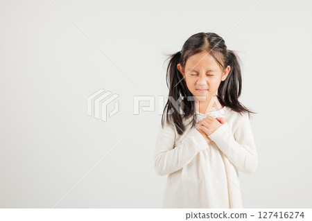 Young kid girl pressing on chest pain isolated on white background, painful expression heartache, kindergarten children having heart attack heart disease, Painful cramps problem Young kid girl pressing on chest pain isolated on white background, painful expression heartache, kindergarten children having heart attack heart disease, Painful cramps problem 127416274