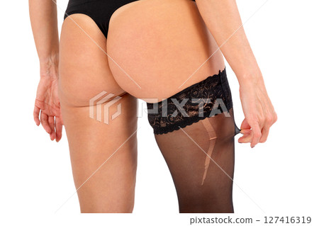 Woman in black stockings with big hole, isolated on white background. Woman in black stockings with big hole, isolated on white background. 127416319