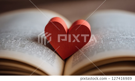 Close-Up of a Red Heart Bookmark in an Open Book 127416989