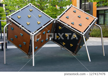 Playground climbing structure with cubical design in modern urban setting 127417476