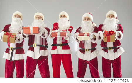 Happy New Year cute group presenting gift box, partying fun wearing Santa Claus holiday costumes 127417678