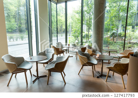 Interior of a nice modern cafe with cozy chairs and round tables Interior of a nice modern cafe with cozy chairs and round tables 127417793