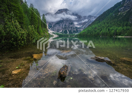 Beautiful alpine lake Braies and mountains in low clouds 127417930