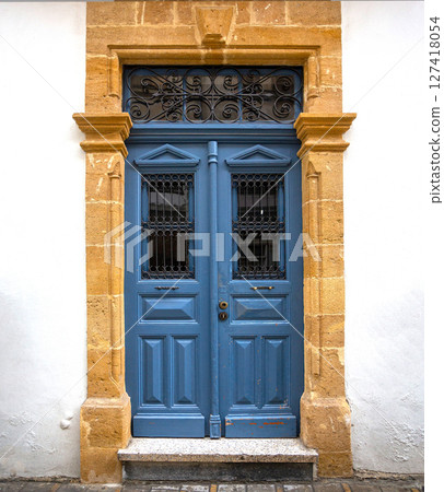 Elegant blue wooden door with ornate wrought iron details in nicosia, cyprus 127418054