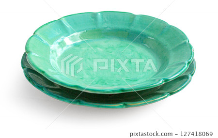 Two green ceramic plates stacked on white background 127418069