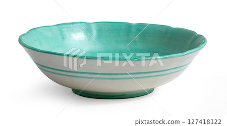 Green and white ceramic bowl standing on white background 127418122