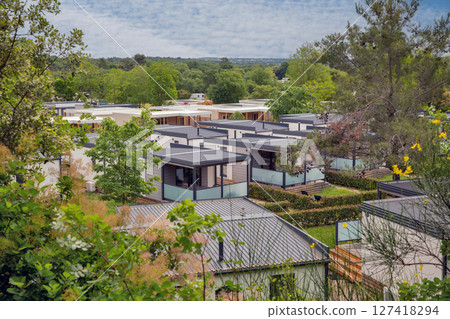Small wooden cabins in forest. Small wooden cabins in forest. 127418294
