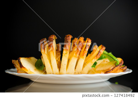 Crispy baked potatoes in a country style Crispy baked potatoes in a country style 127418492