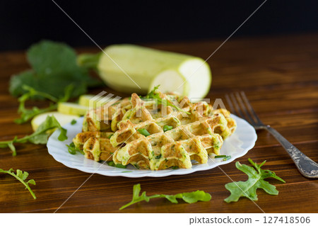 Vegetarian zucchini waffles served on a wooden table 127418506
