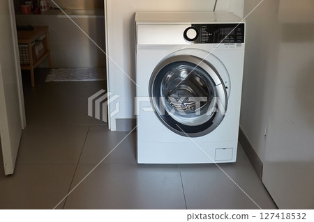 Washing machine in a bathroom Washing machine in a bathroom 127418532
