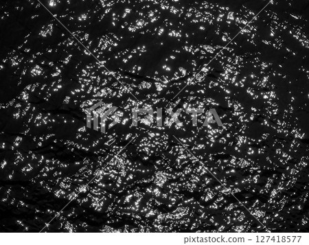Water surface high contrast top view. Sun glare on water black and white edit. Background abstracted wallpaper texture Water surface high contrast top view. Sun glare on water black and white edit. Background abstracted wallpaper texture 127418577