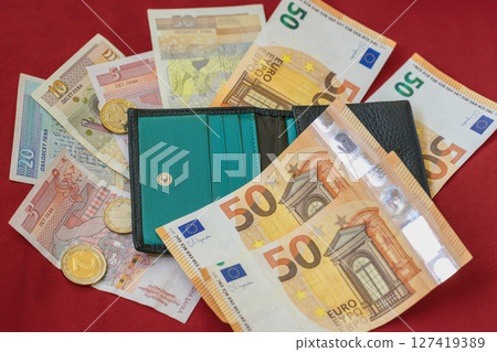 Wallet with euro and Bulgarian lev banknotes and coins on red background. Bulgaria, transition to Euro, finance and budgeting. Concept of personal money, savings, financial international spending Wallet with euro and Bulgarian lev banknotes and coins on red background. Bulgaria, transition to Euro, finance and budgeting. Concept of personal money, savings, financial international spending 127419389