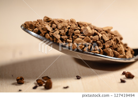 Spoonful of Instant Coffee Granules in Warm Light 127419494