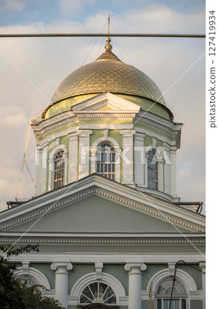 A clock tower in front of a building 127419934