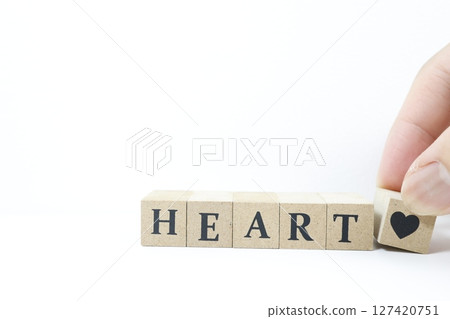 The English word HEART and a heart symbol are written on wooden blocks The English word HEART and a heart symbol are written on wooden blocks 127420751